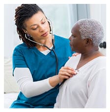 Home caregiver nurse examines elderly patient